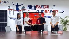 Photo of the two parties signing the agreement